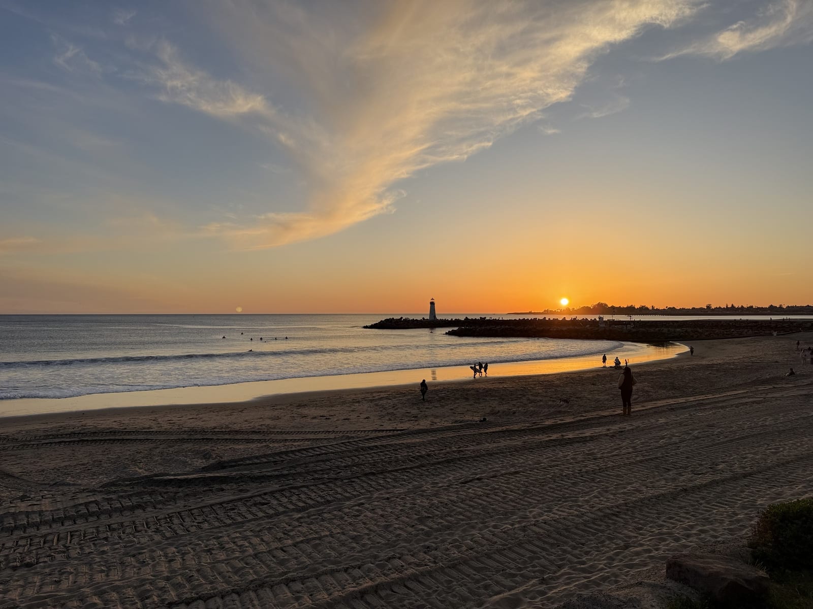 Sunset over the Walton Lighthouse and the harbor beach in Santa Cruz